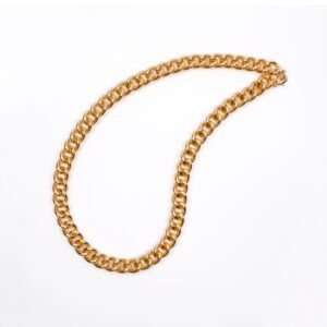 Gold initial pendant necklace on a neutral background (product photo for &django).