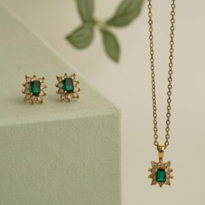 Coordinated earrings and necklace gift set styled on a neutral background (product photo for &django).