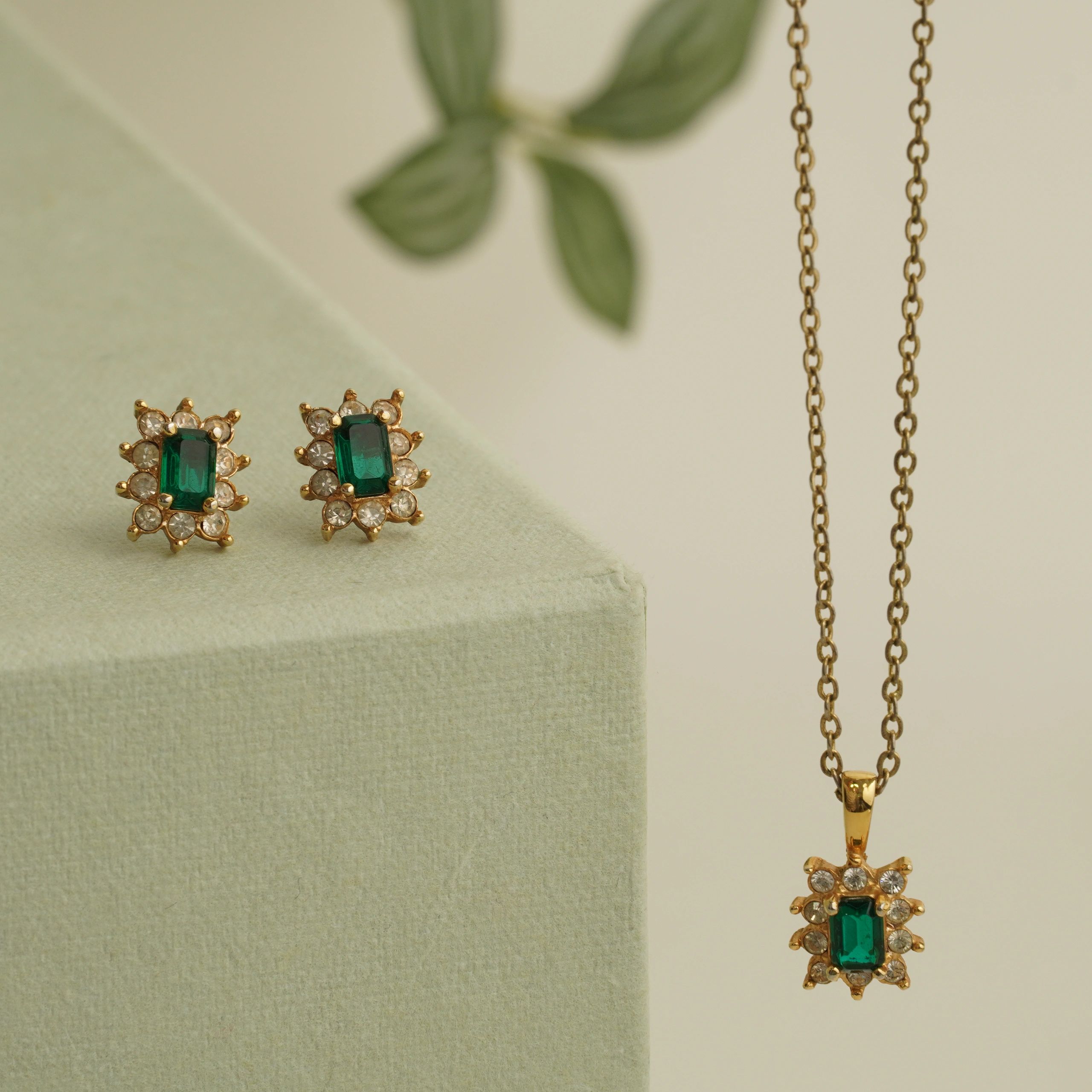 Coordinated earrings and necklace gift set styled on a neutral background (product photo for &django).